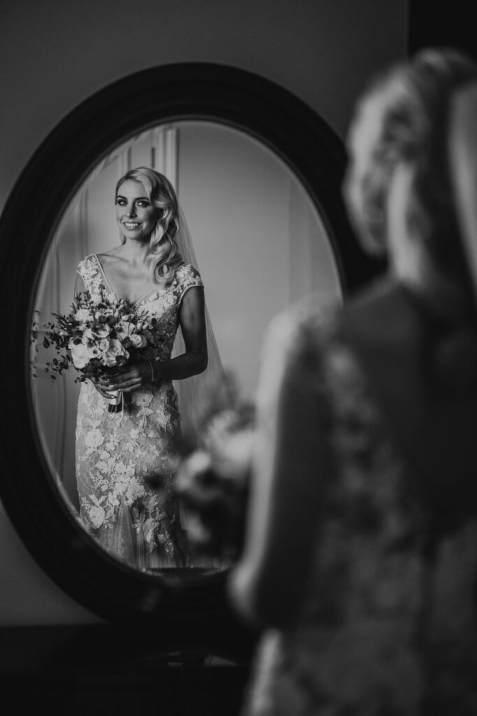 Black and white image of a bride's reflection in a mirror, captured by Darren Byrne, Wedding Photographer in Ireland.