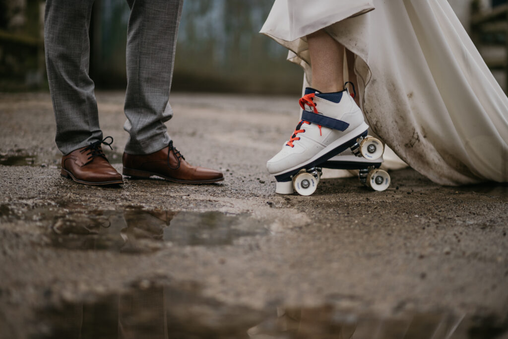 Feet of bride and groom standing by a puddle, reflecting their wedding attire – captured by Darren Byrne, Wedding Photographer in Ireland.