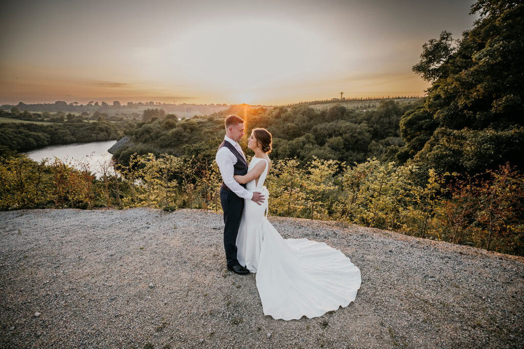 Bride and groom looking at each other near cliffside at golden hour. Even a casual look between the couple becomes pure movie magic in the right light.