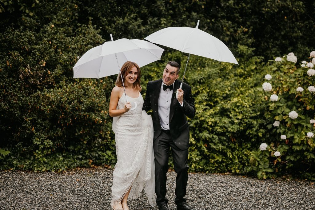 Irish wedding couple having fun in the rain on their wedding day