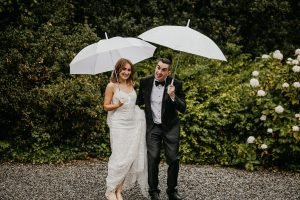 Irish wedding couple having fun in the rain on their wedding day 